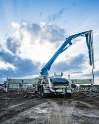 Crane at construction site against sky