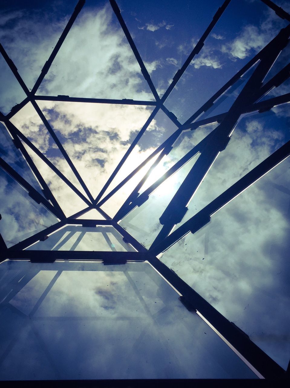 low angle view, sky, built structure, architecture, cloud - sky, cloud, cloudy, day, directly below, no people, metallic, architectural feature, modern, blue, outdoors, part of, geometric shape, engineering, tilt