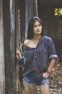 Portrait of young woman standing outdoors