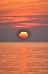 Scenic view of sea against romantic sky at sunset