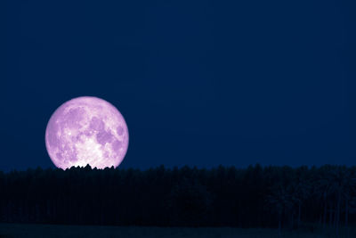 Scenic view of moon against blue sky at night