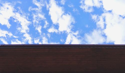 Low angle view of building against cloudy sky