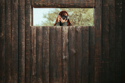 Woman holding camera at observation point