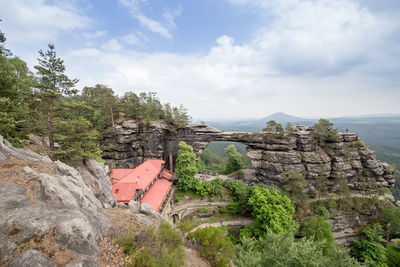 Built structure on cliff against sky