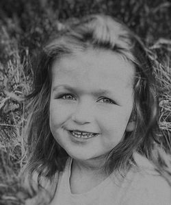 Close-up portrait of smiling young woman