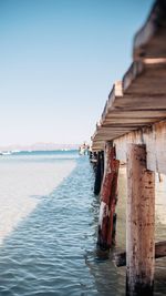 Pier over sea against clear sky