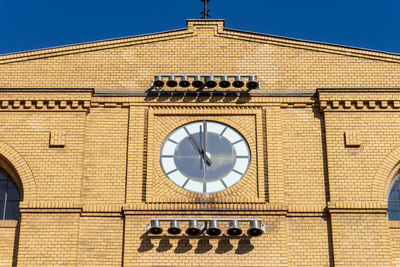 Low angle view of clock tower against building