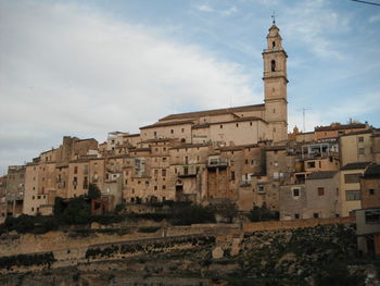 Old buildings in city against sky