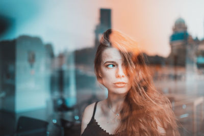 Woman looking away in window