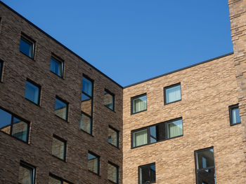 Low angle view of building against clear blue sky