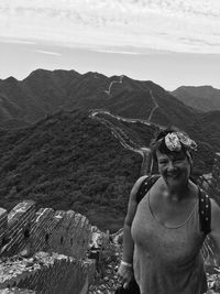 Portrait of woman standing on mountain against sky