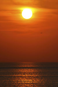 Scenic view of sea against orange sky