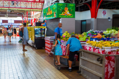 People walking at market stall in city