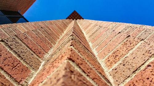 Low angle view of historic building against blue sky