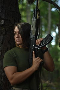 Cropped hand of man standing in forest