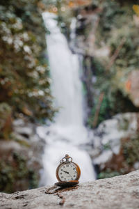 Close-up of clock on rock