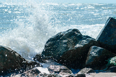Close-up of sea waves splashing on rocks