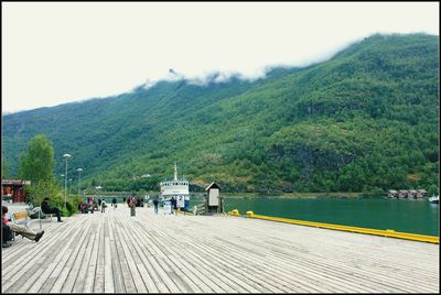Scenic view of lake by mountains against sky