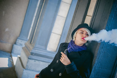 Young woman smoking electronic cigarette