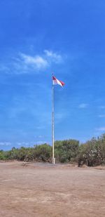 Flag on field against sky