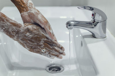 Close-up of faucet in bathroom