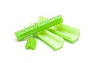 Close-up of green chili pepper against white background