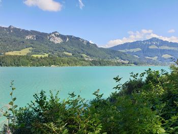 Scenic view of lake and mountains against sky