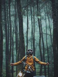 Man with motorcycle in forest
