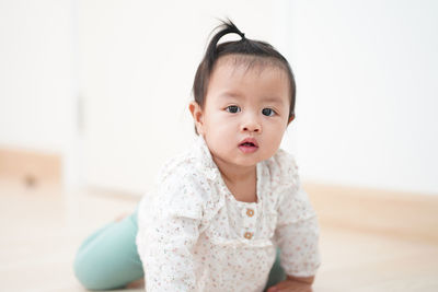 Portrait of cute baby girl at home