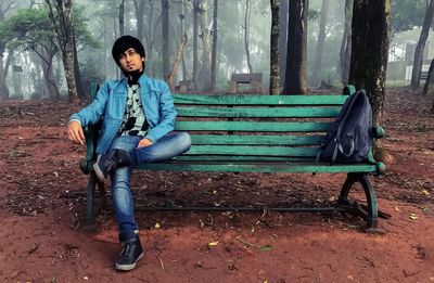 Portrait of young man sitting on chair