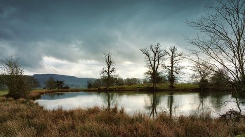 Scenic view of lake against cloudy sky