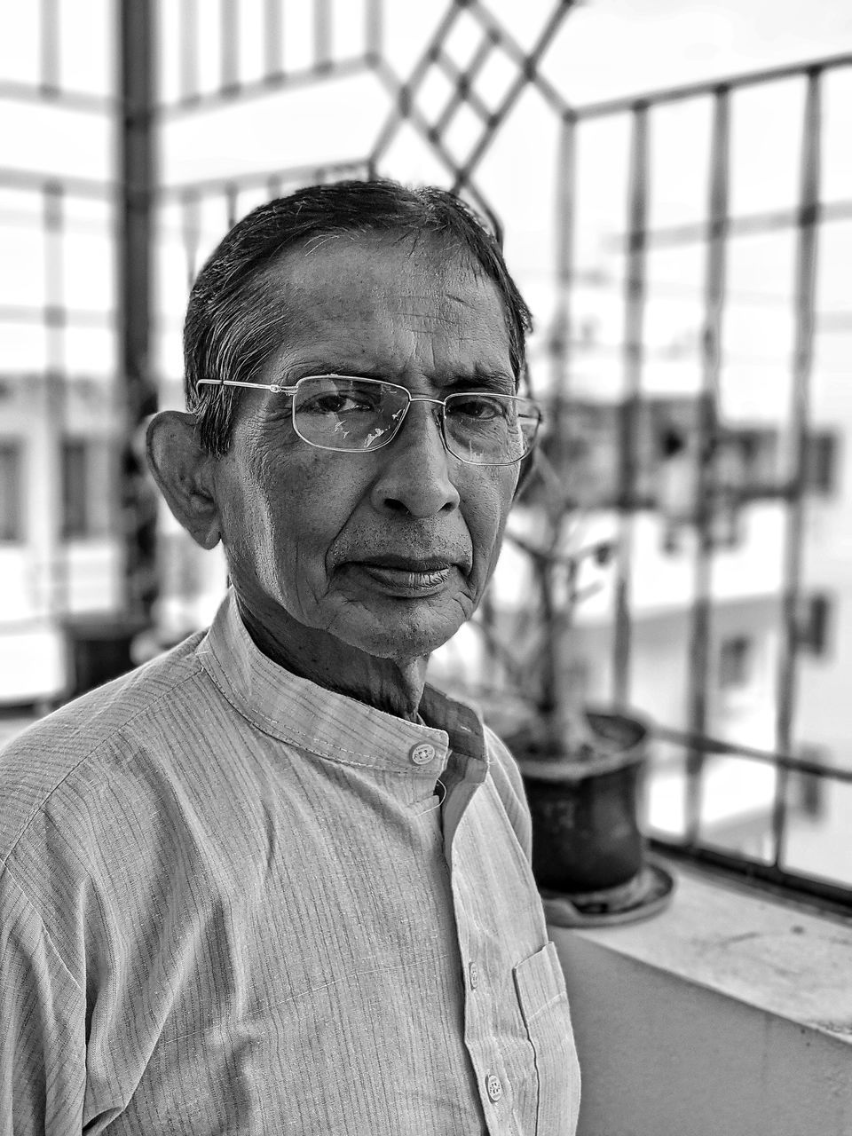 adult, one person, portrait, black and white, glasses, eyeglasses, senior adult, men, person, monochrome, monochrome photography, mature adult, architecture, lifestyles, headshot, focus on foreground, seniors, looking at camera, day, looking, casual clothing, indoors, human face, standing