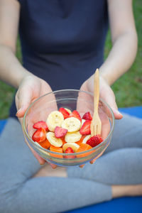 Midsection of woman holding fruits