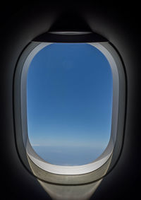 Blue sky seen through airplane window