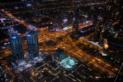 High angle view of city lit up at night