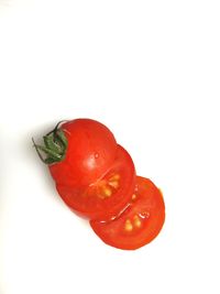 Close-up of red chili over white background