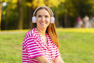 Portrait of young woman standing outdoors