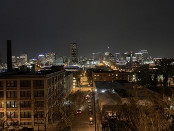 High angle view of illuminated buildings against clear sky at night