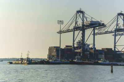 Commercial dock by sea against sky