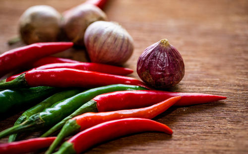 Close-up of red chili peppers on table