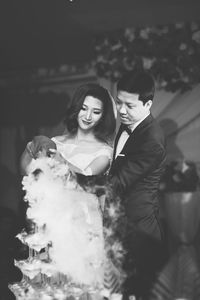 Bride and groom pouring drink during wedding ceremony