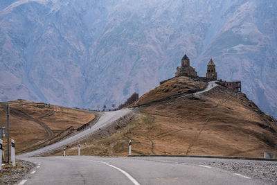 Road amidst mountains against sky