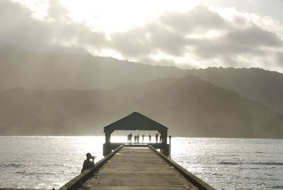 Pier over sea against sky