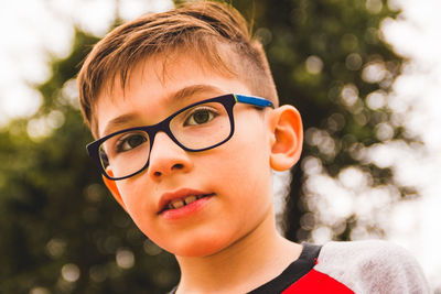 Close-up portrait of cute boy wearing eyeglasses