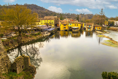 High angle view of borghetto sul mincio with the buildings reflecting on the water