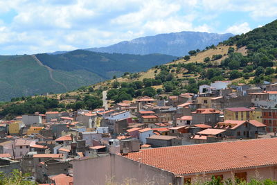 High angle view of townscape and mountains against sky