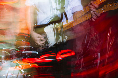 Blurred scene of guitar player playing an electric guitar on stage