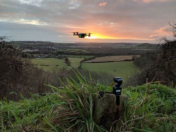 Scenic view of land against sky during sunset