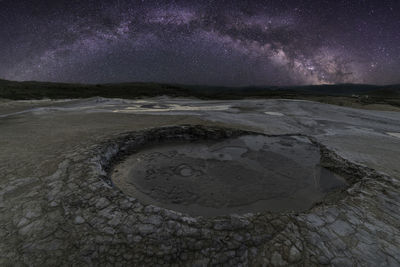 Scenic view of beach against sky at night