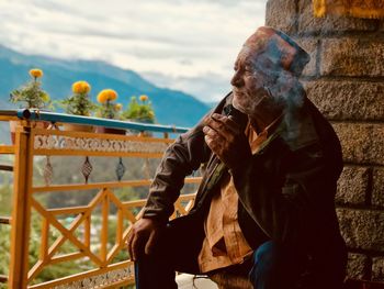 Thoughtful senior man sitting outdoors